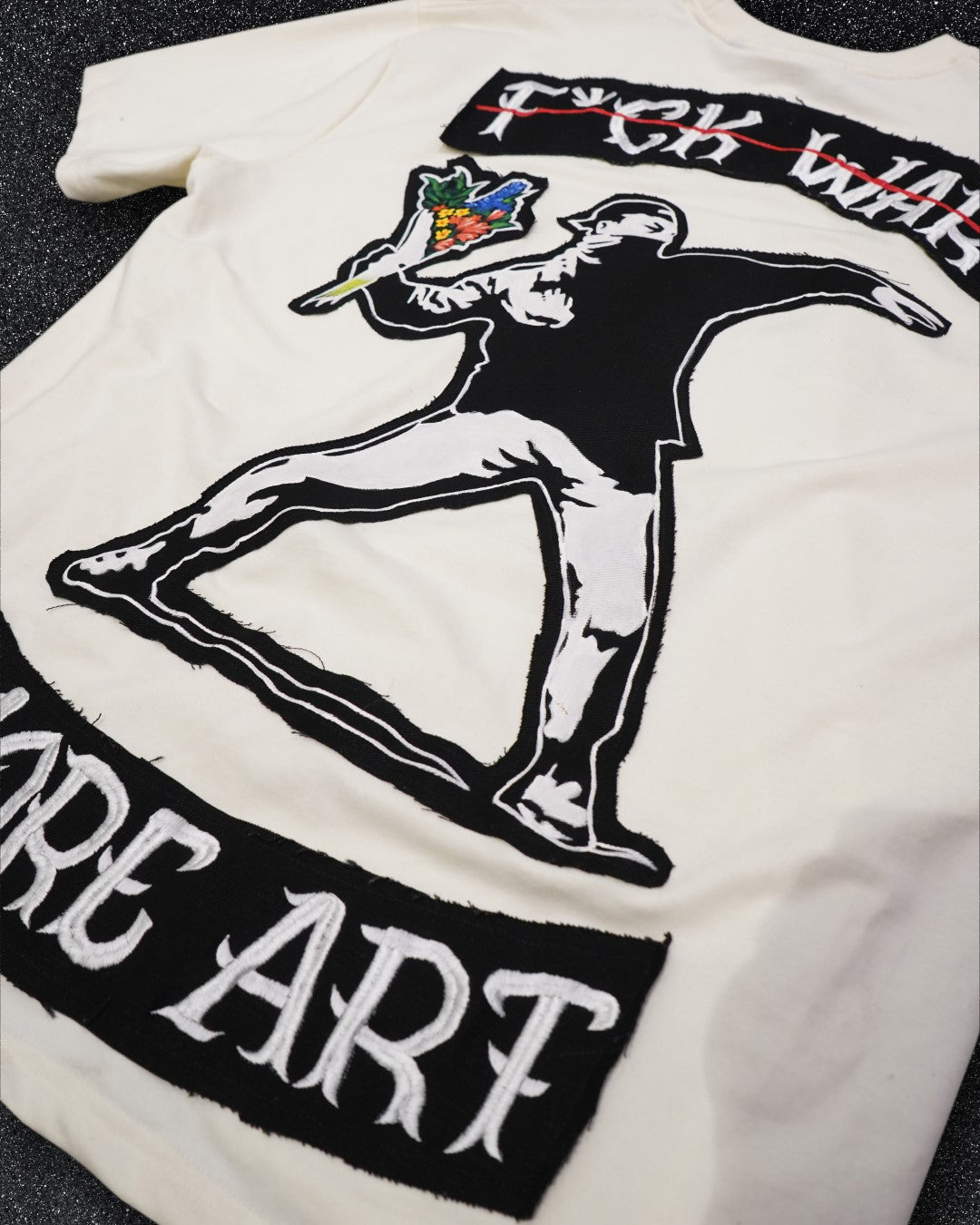 BANKSY 'F*CK WAR, MORE ART' OFF WHITE VALKYRE TSHIRT